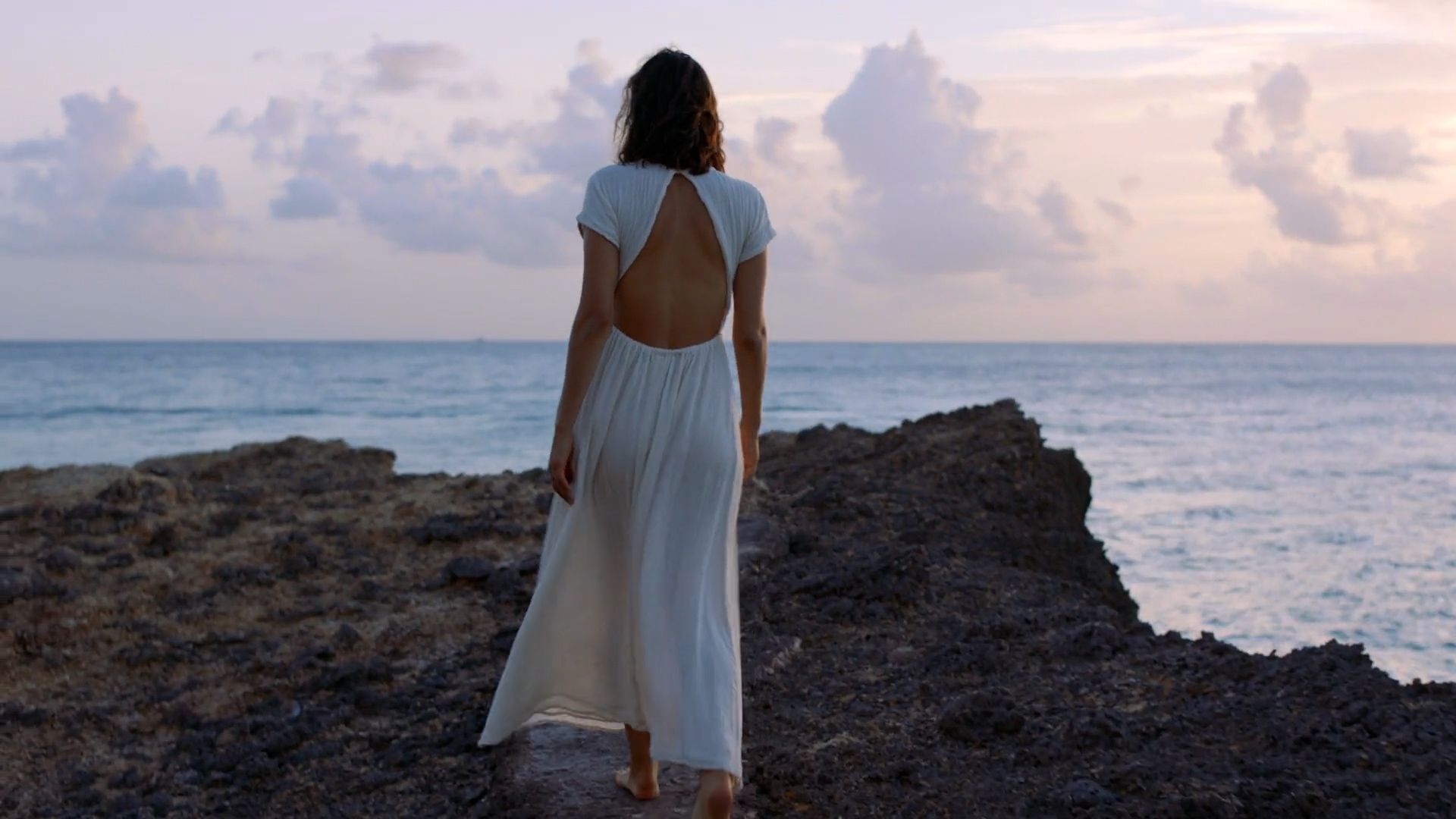 Woman walks on beach