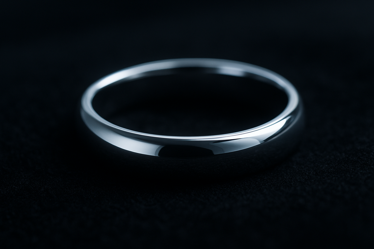 Polished platinum wedding band reflecting cool light on black velvet