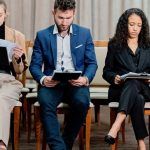 group-of-people-sitting-on-brown-wooden-chairs