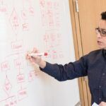 Courses. A teacher writing on a white board.