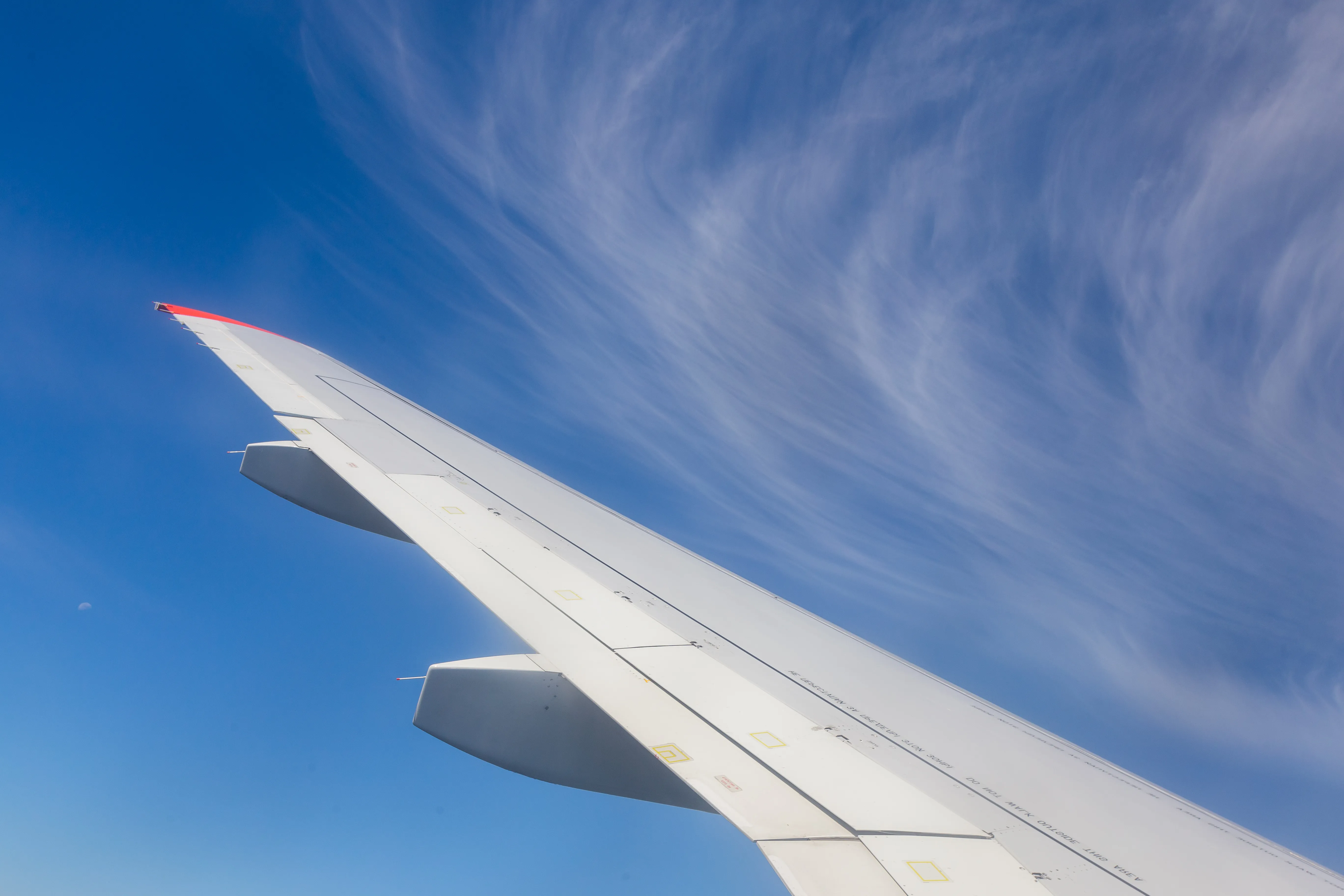 view of airplane wing from inside the plane