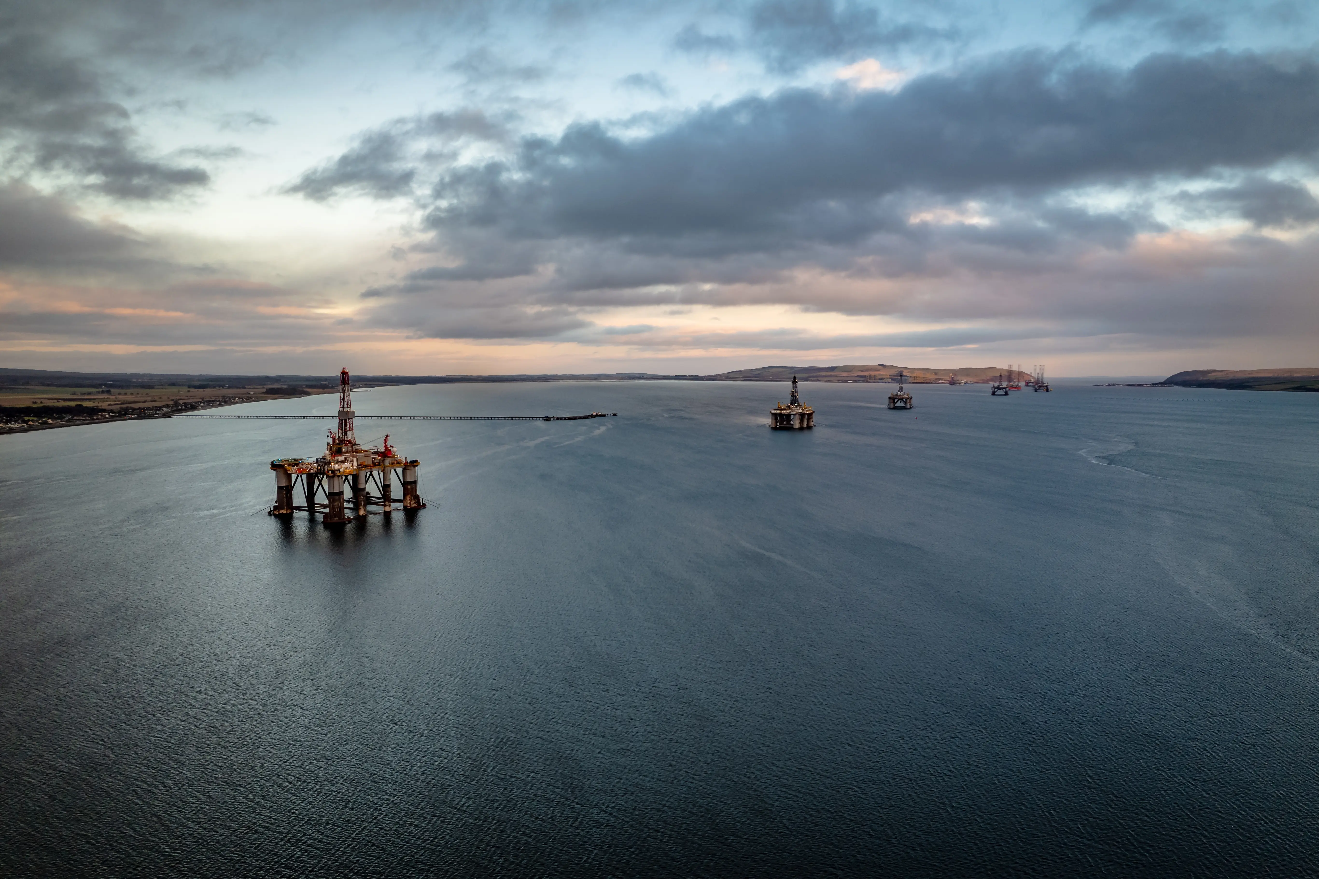 oil rigs at sunset