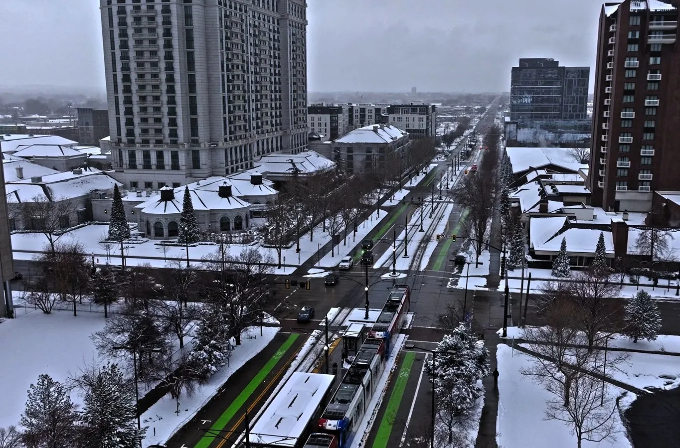 light rail goes through a snowy downtown in the USA