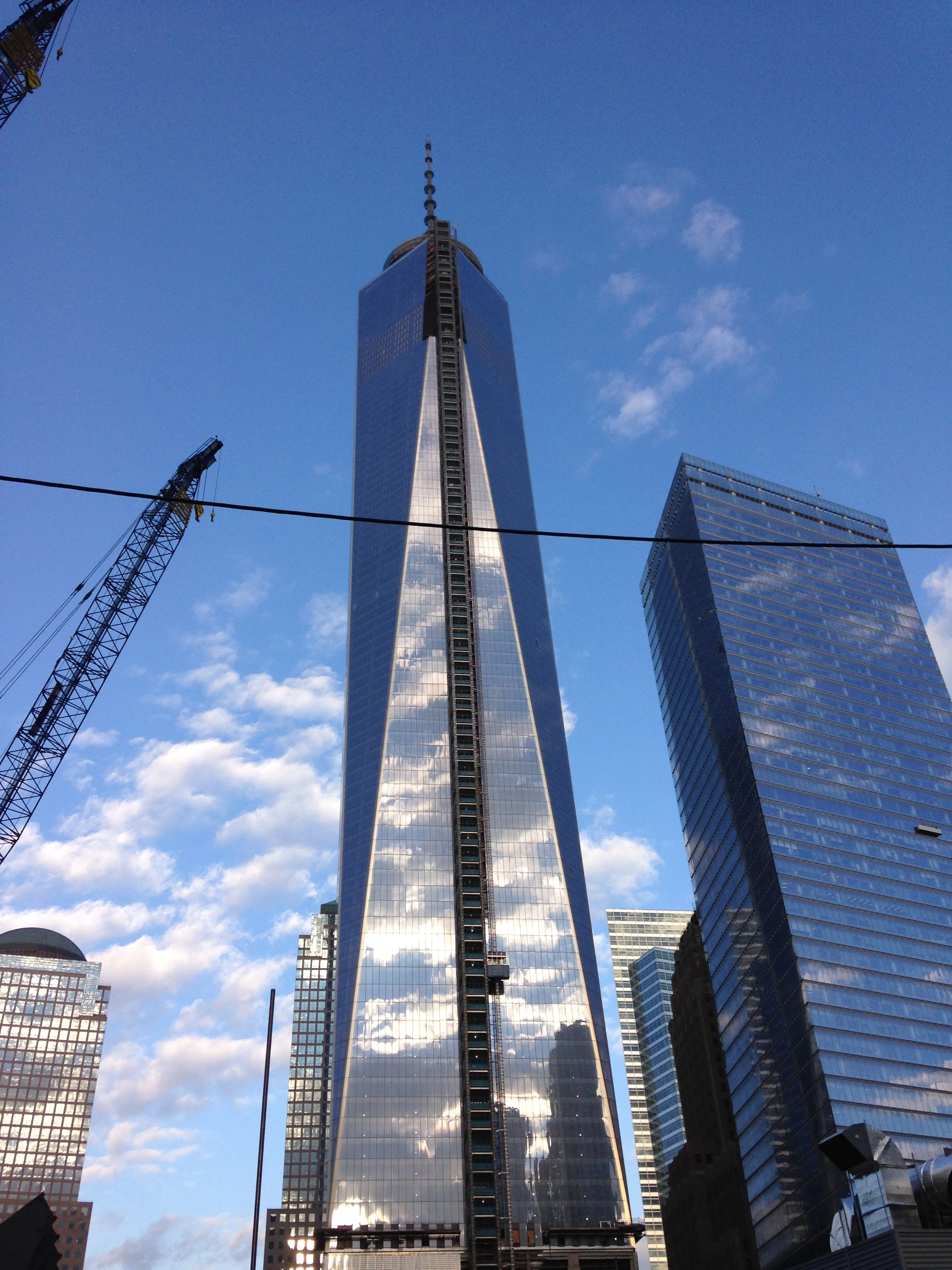 one world trade center freedom tower against blue sky with clouds