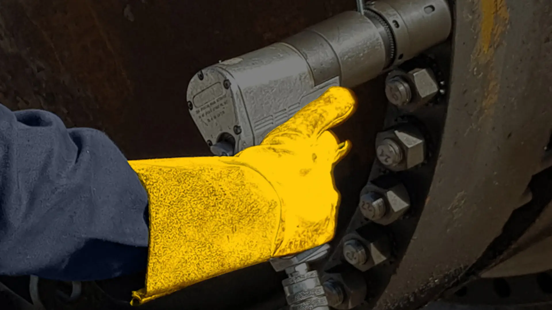 gloved hand using hytorc pneumatic tool with reaction washer