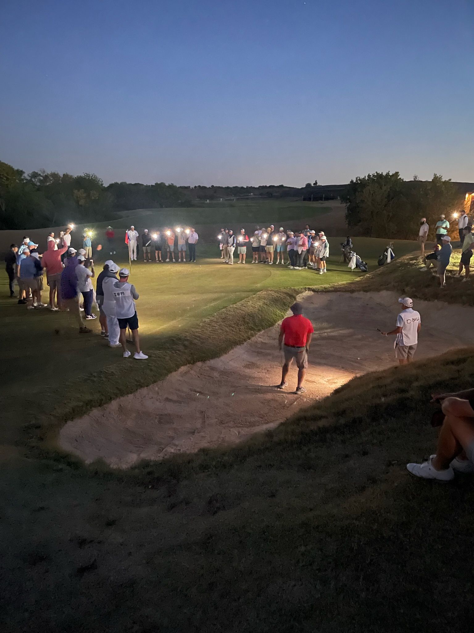 Attendees of the Nest Invitational Tournament light up the 18th green in the final moments of the 2023 Nest Invitational Tournament.