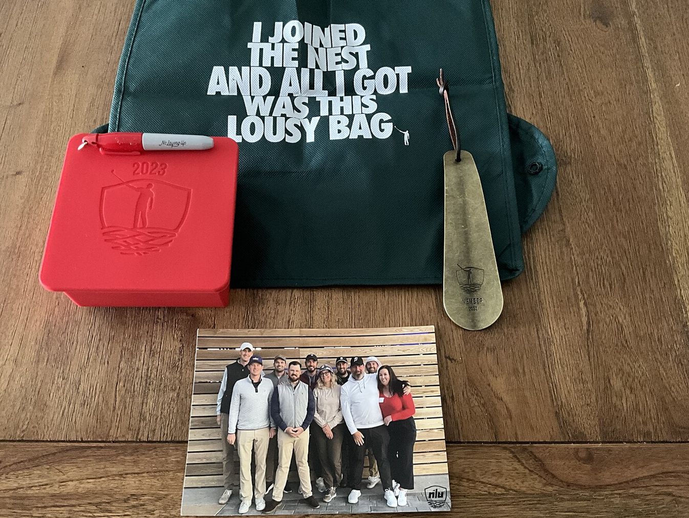 The 2023 Nest Member Gift: A shoehorn, a reusable bag, an NLU sharpie and an NLU ice mold.