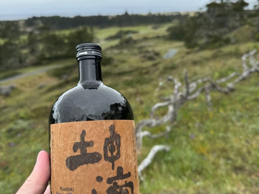 TC holds up some sake to Bandon Dunes in the background.