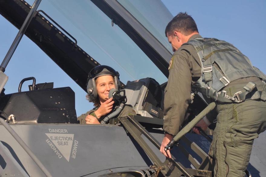 Rachel Heck sits in the cockpit of a fighter jet