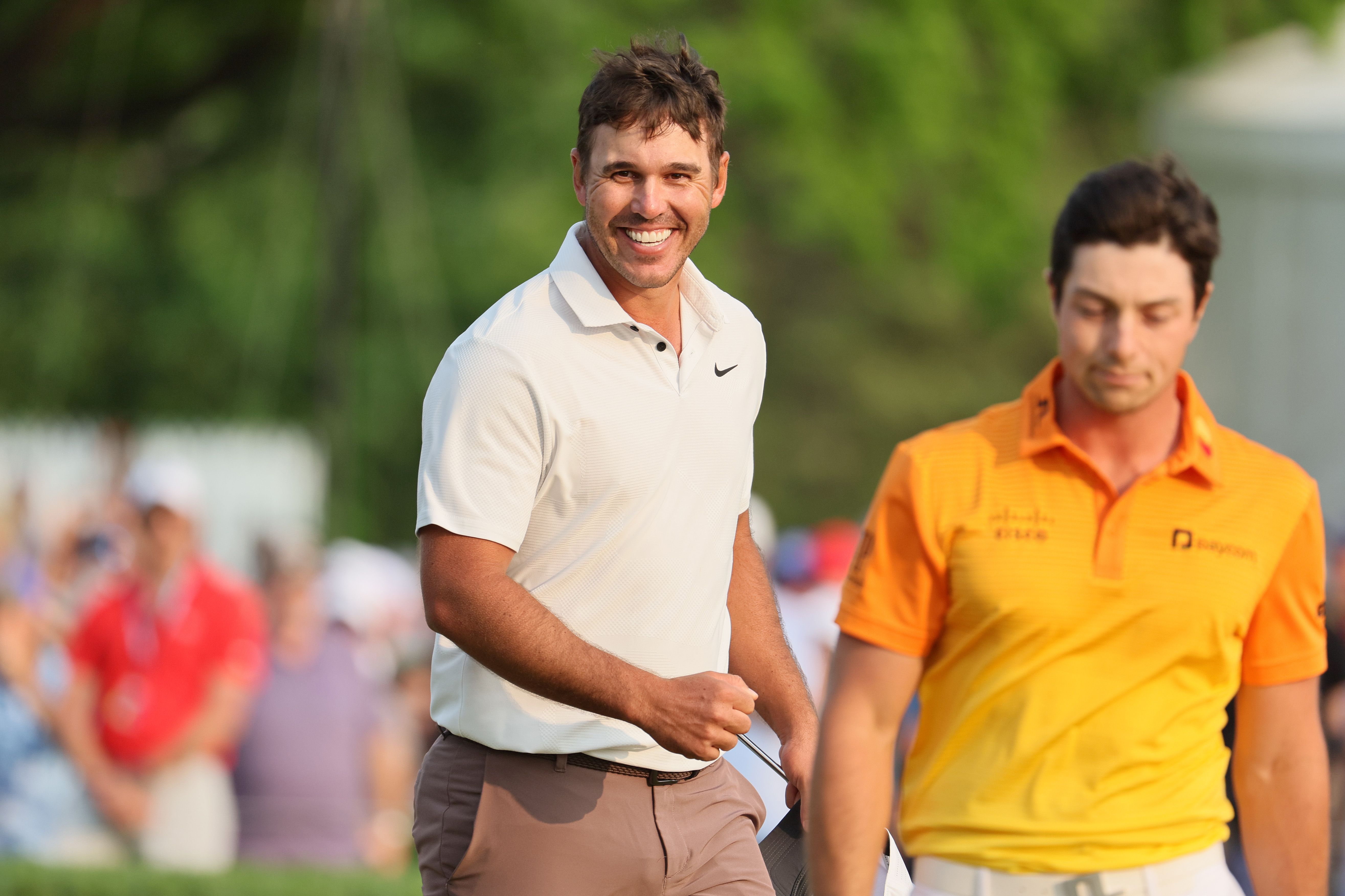 Brooks Koepka rejoices in his victory at the 2023 PGA Championship, while Viktor Hovland sulks to his right.