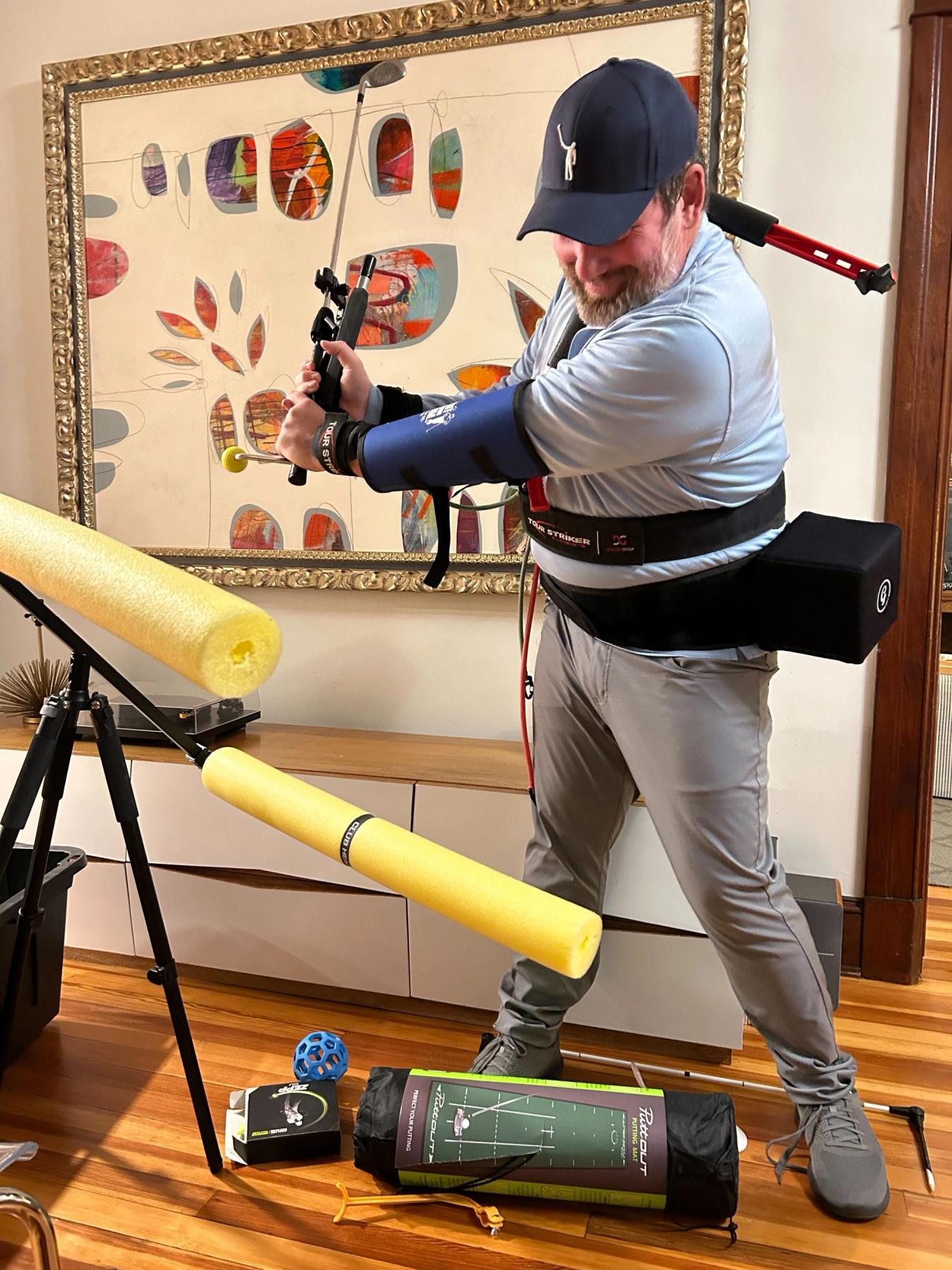 KVV proudly displays his collection golf training aids.