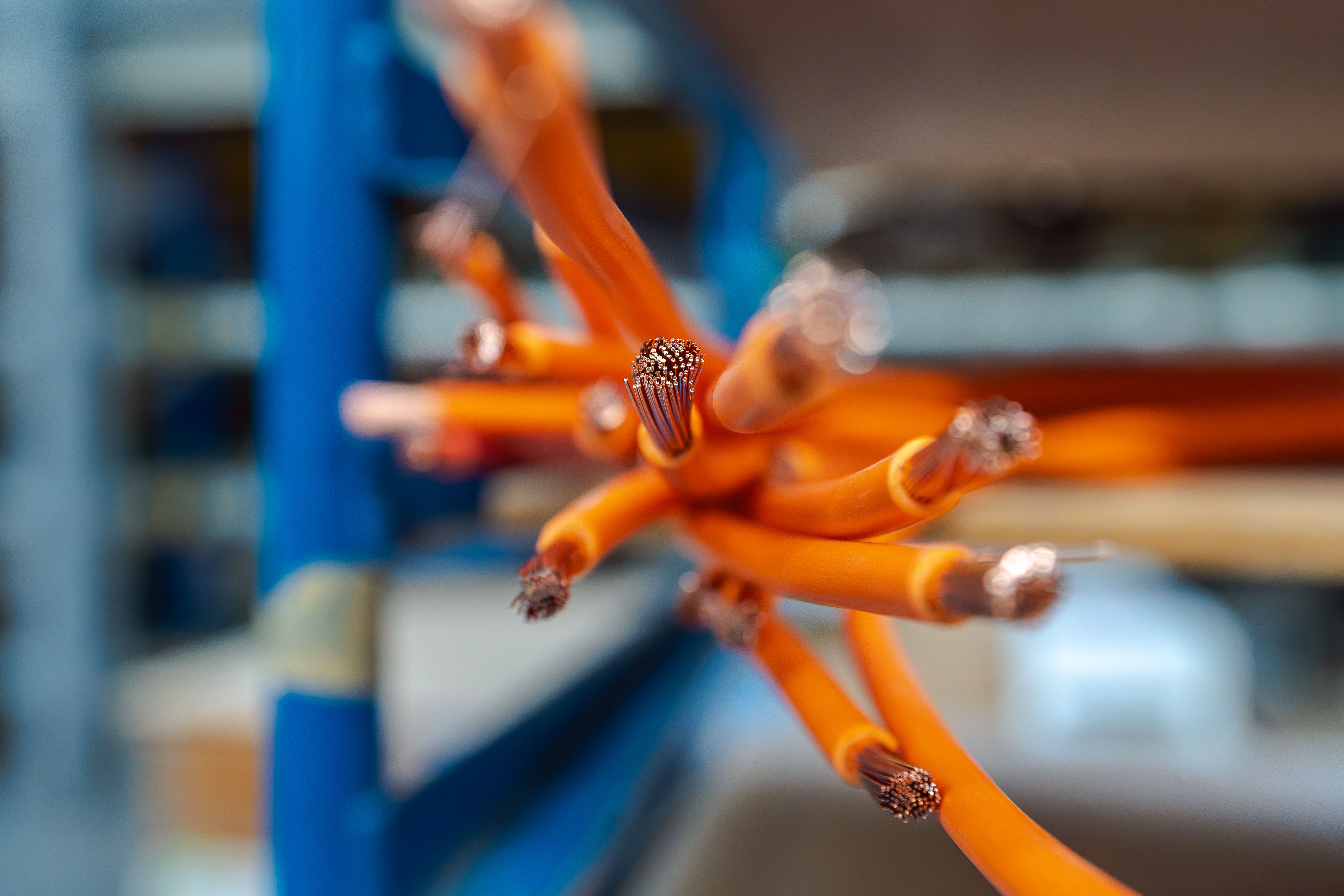 Plusieurs câbles électriques orange dénudés au bout