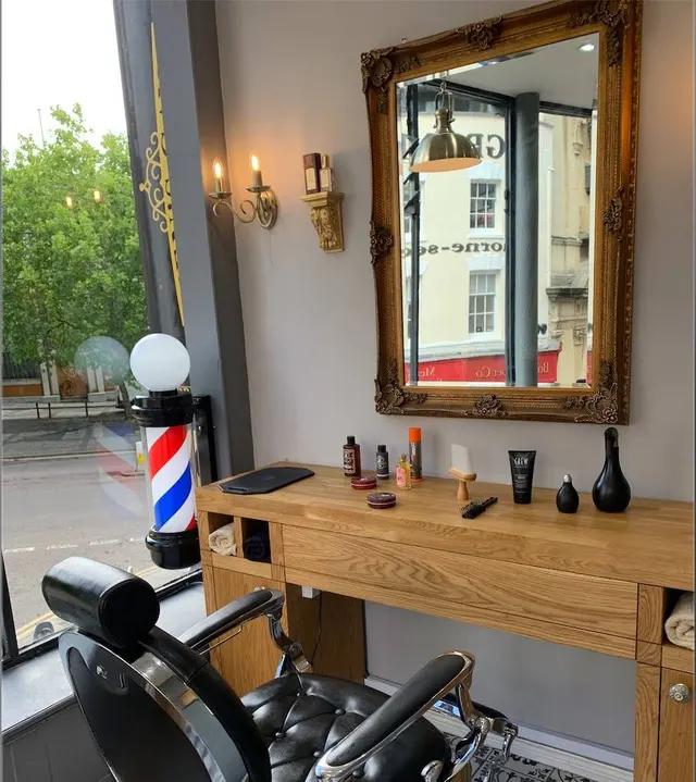 A barber station at Men's Cave Barbers, with vintage barber pole