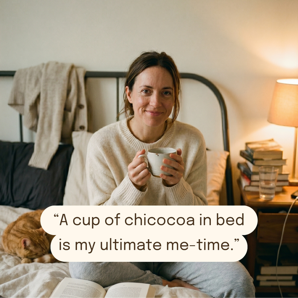 Melanie enjoying a cup of Chicocoa in bed with her cat