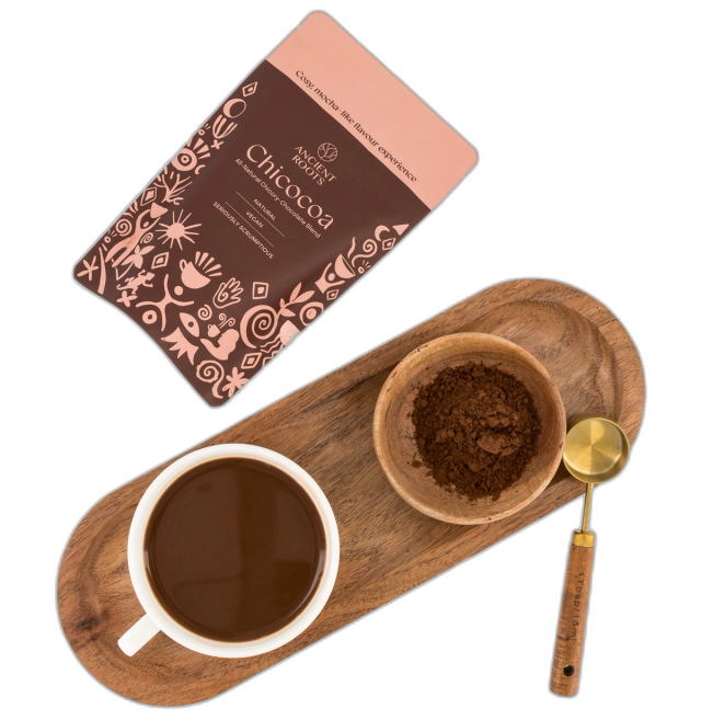 Chicocoa package lying flat next to tray with a freshly prepared cup.