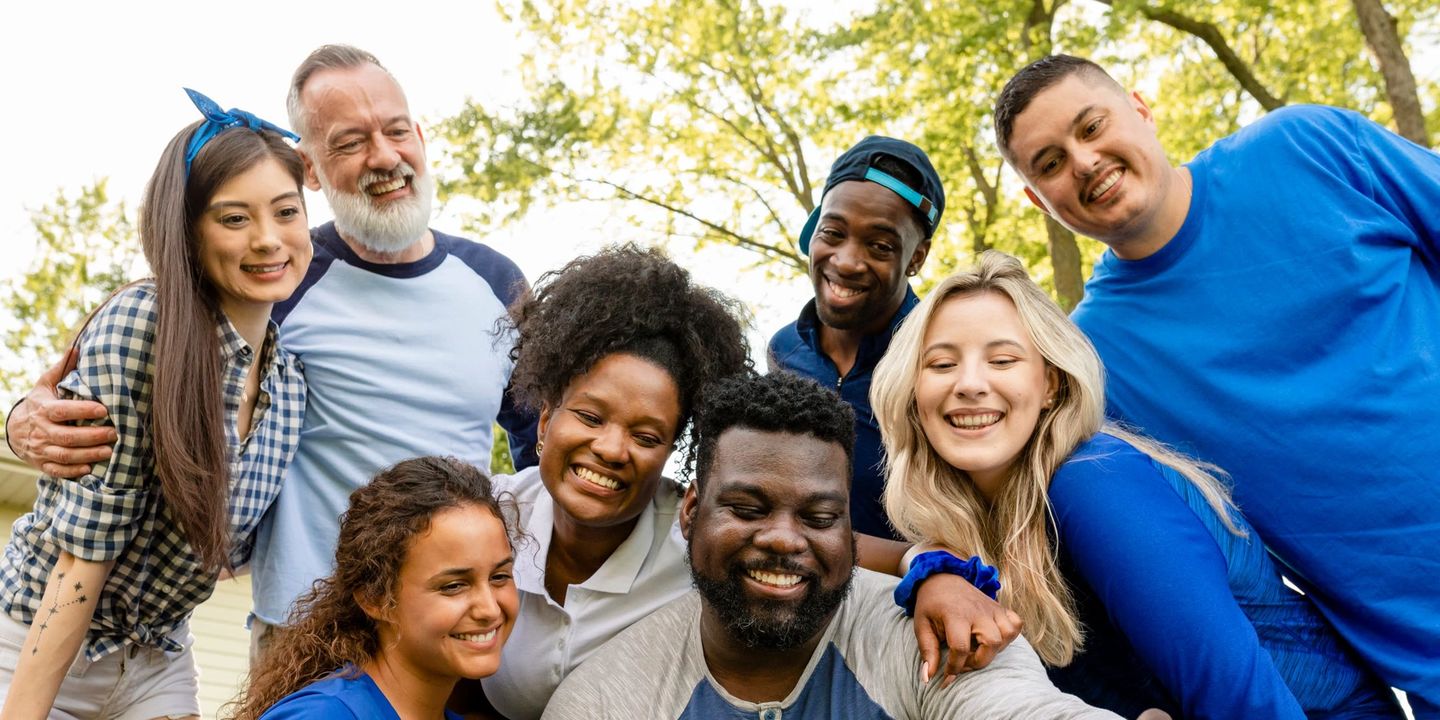 A diverse group of friends taking a selfie together outdoors
