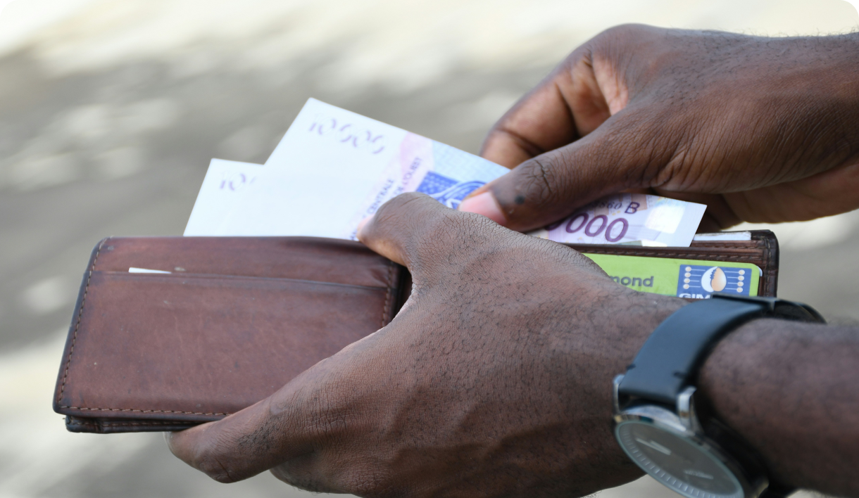 Person counting cash from wallet