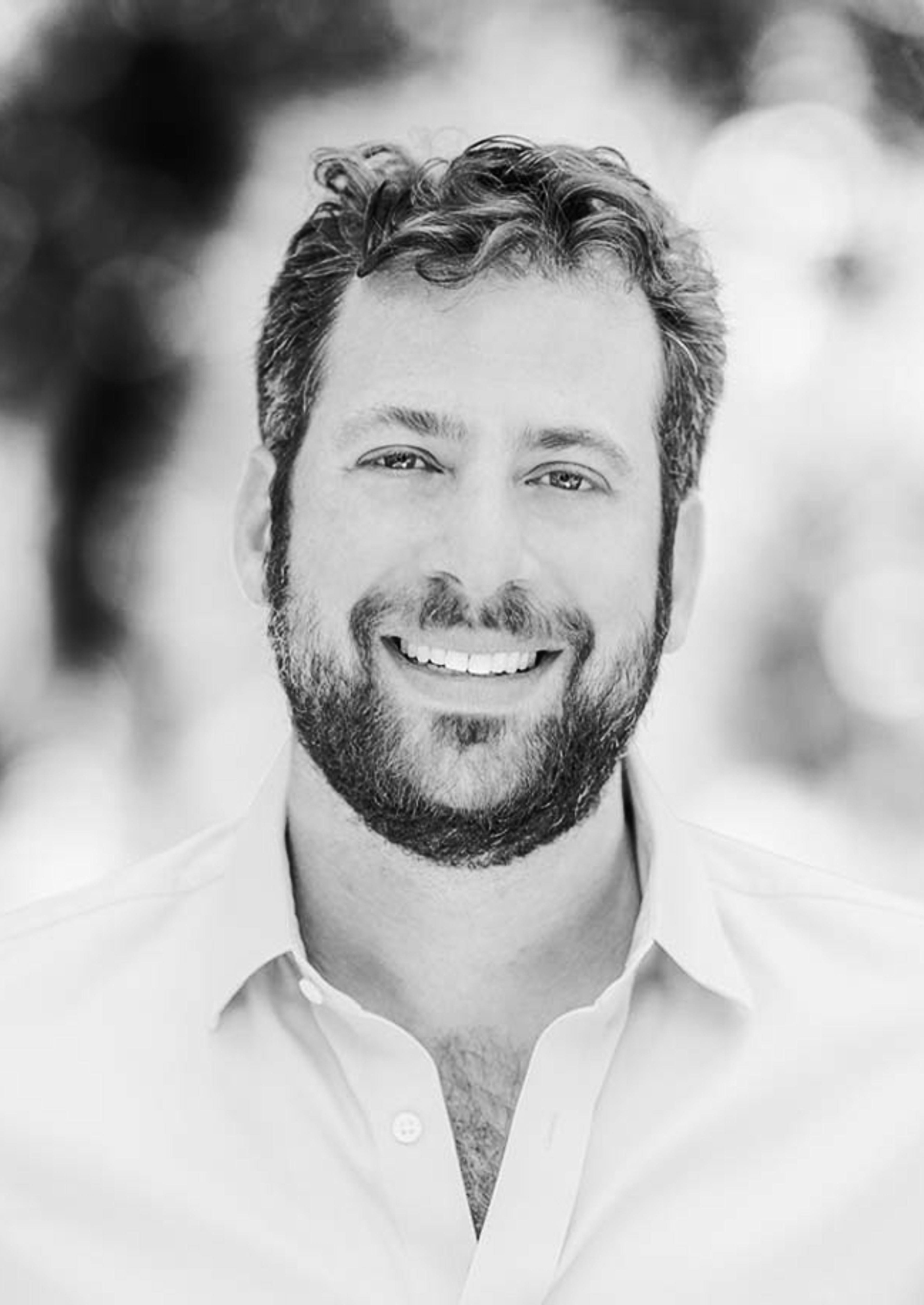 A black and white portrait of Brian Ezra
