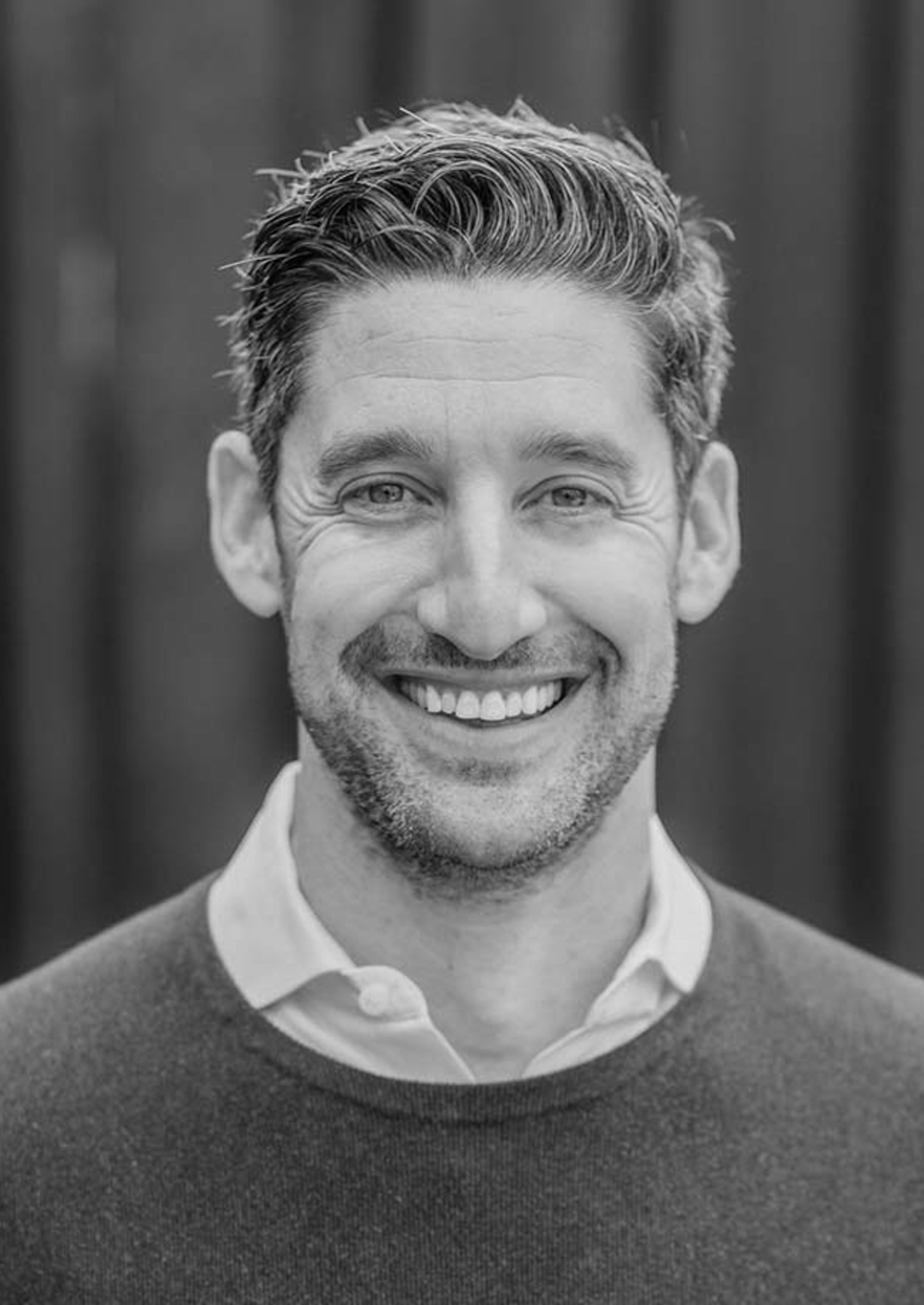 A black and white portrait of Avi Fisher.