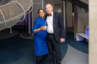 Two people posing in front of the National Children's Museum Dream Machine