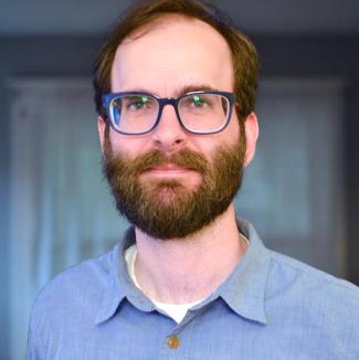 Headshot of Tommy Bobo wearing a blue button-up shirt