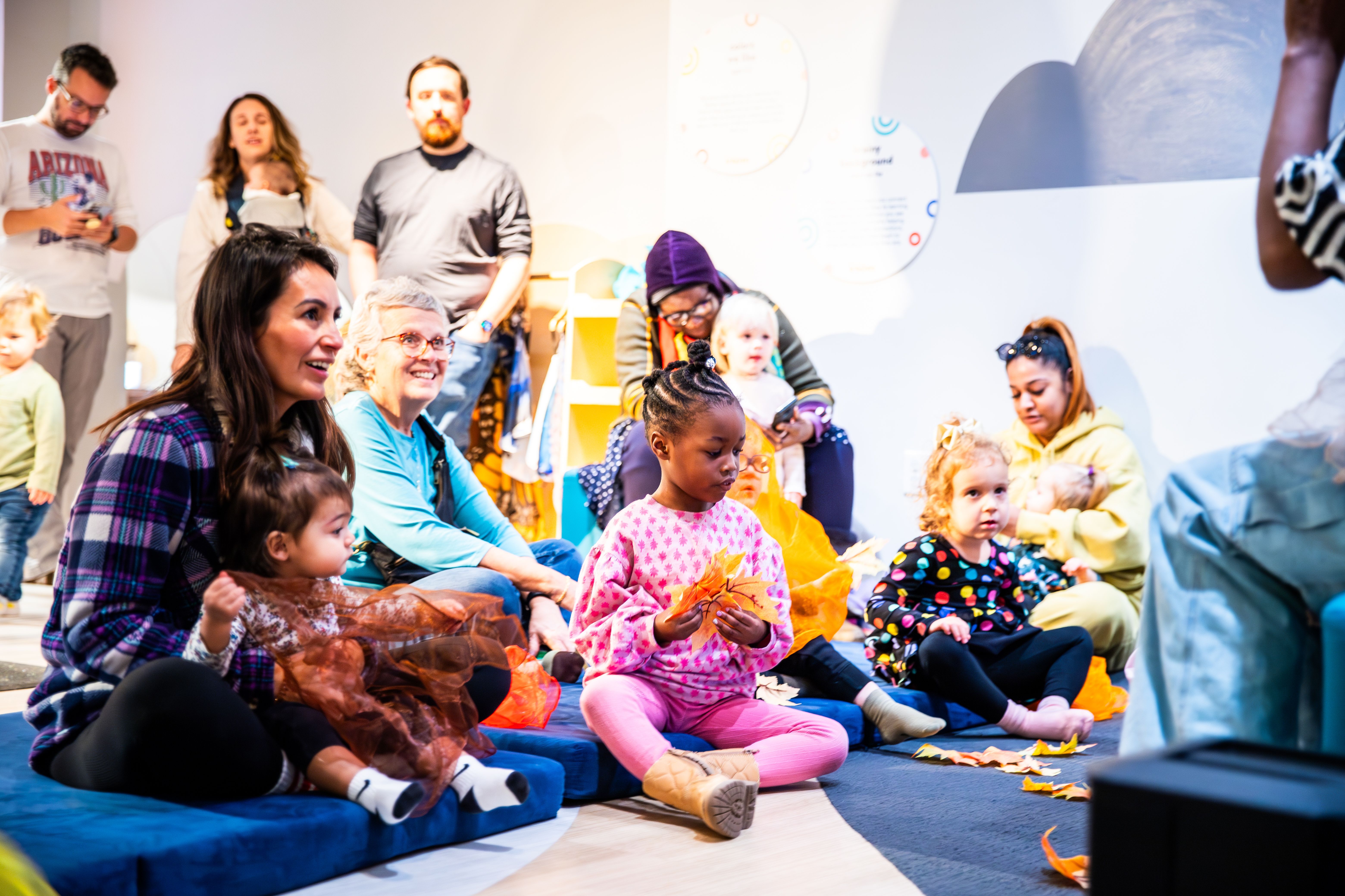 adults and kids sitting together for storytime