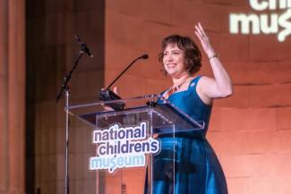 Kiryn Hoffman on stage at the National Children's Museum Play Soiree at the Mellon Auditorium