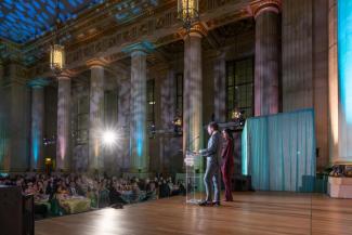 Event co-chairs, Jason and Sepe Zuccari, on stage at the National Children's Museum Play Soiree
