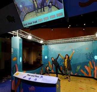 People posing for a picture in a large aquarium-themed photo studio