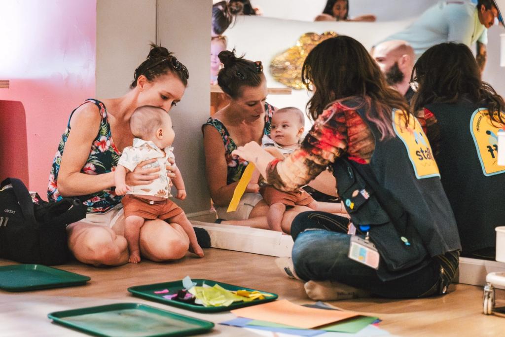 woman with baby and staff member with art