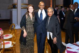 People in formal wear posing at the National Children's Museum gala