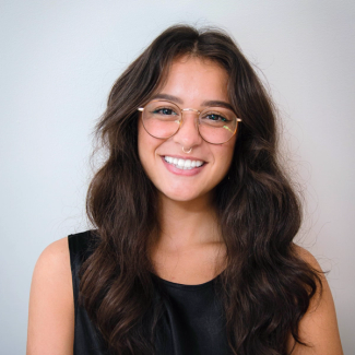 Headshot of Madelyn Leembruggen wearing a black sleeveless shirt