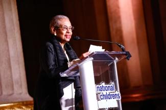 People in formal wear posing at the National Children's Museum gala