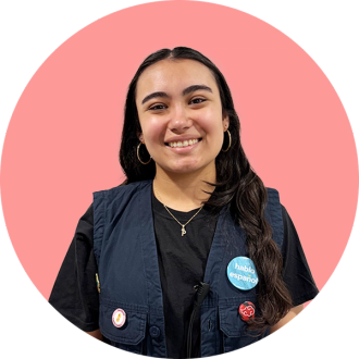 headshot of paola bonilla on a coral pink circle background