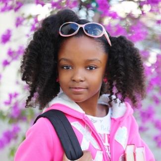 Child Investigator Kaedence wearing purple sweater and backpack 