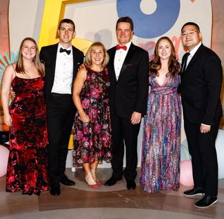 People posing in front of the National Children's Museum Dreamers Gala step and repeat.