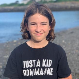 Child Investigator Will wearing a black t-shirt at the beach