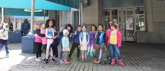Two girl scouts participating in an activity at Girl Scouts Day.