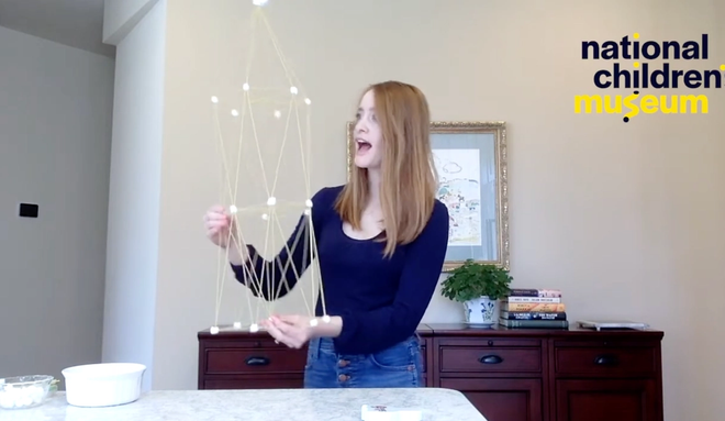 A woman admiring her pasta tower