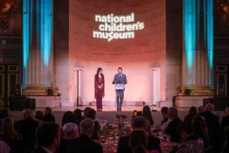 Event co-chairs Sepe and Jason Zuccari on stage at the National Children's Museum Play Soiree