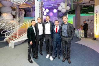 People in formal wear posing at the National Children's Museum afterparty