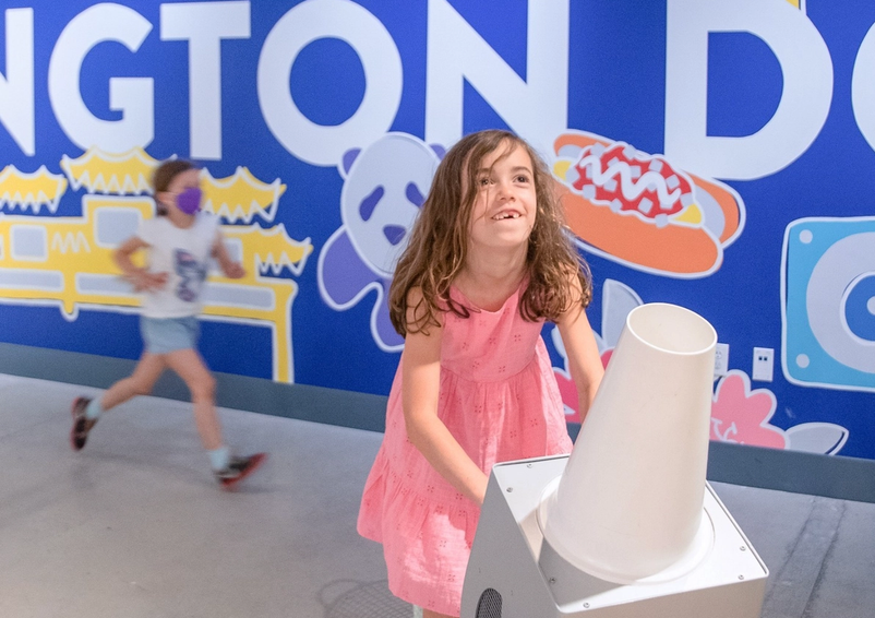 Young girl at Bernoullis Hoops in the Engineering Games and Play exhibit