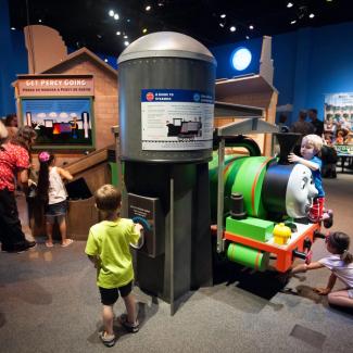 Group of children playing near a life-sized Percy the train