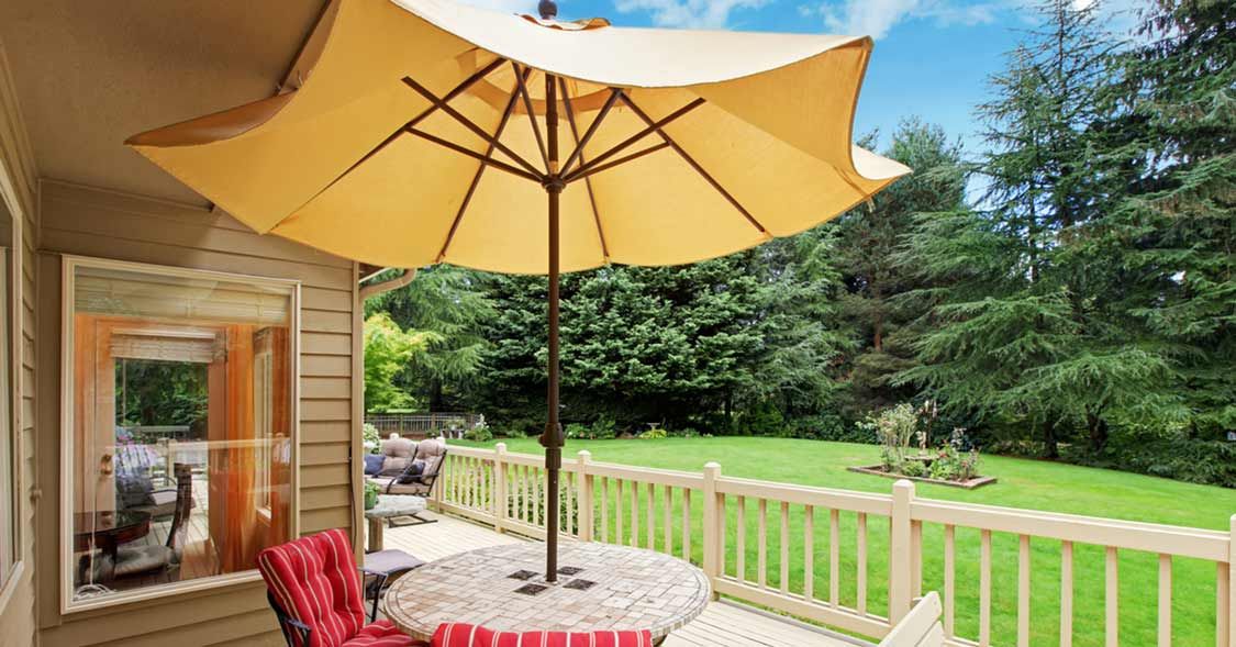 Patio Furniture Surrounding a Table with an Umbrella | Patio Life