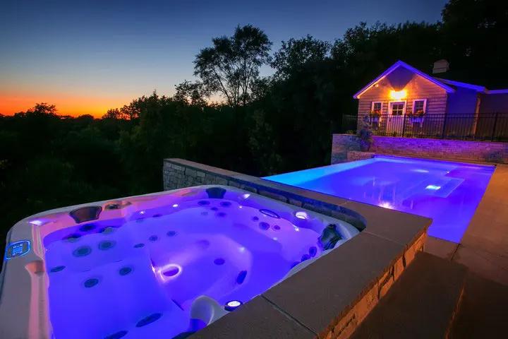 Upscale Hot Tub and Pool Lit Up for Nighttime | Patio Life