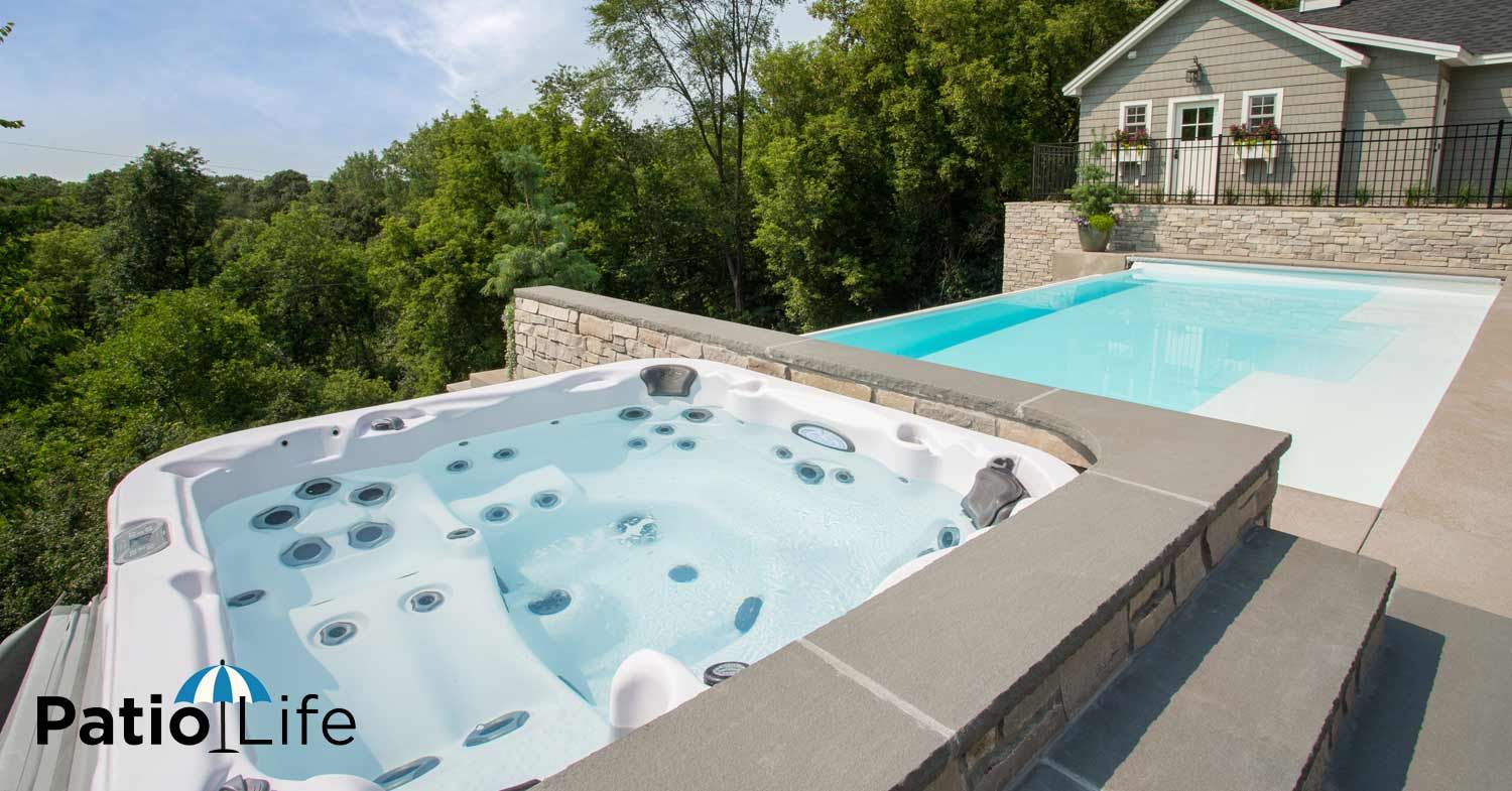 Large Pool and Hot Tub Overlooking Trees on a Patio | Patio Life