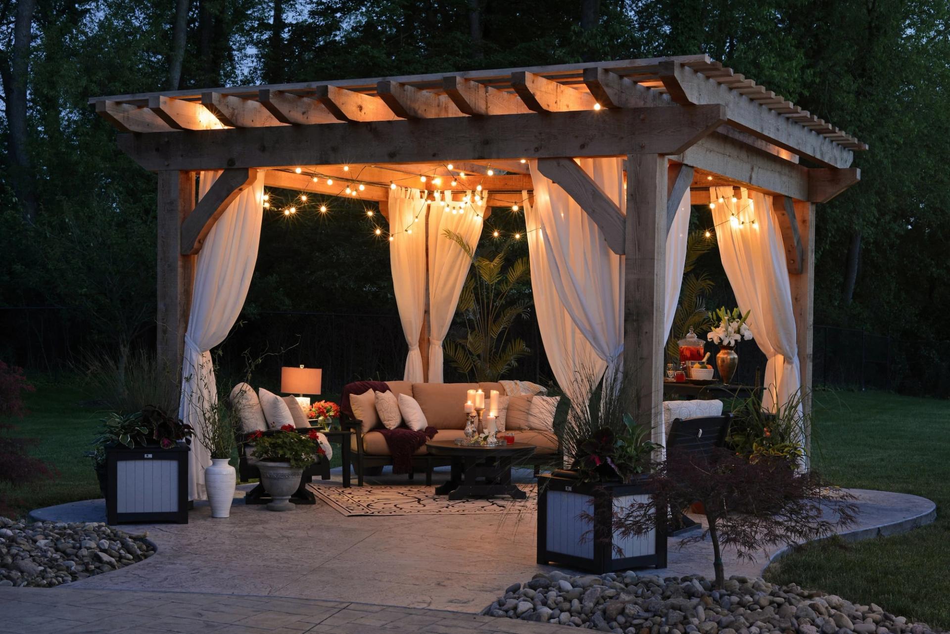 A nicely decorated patio at night with Patio Life furniture