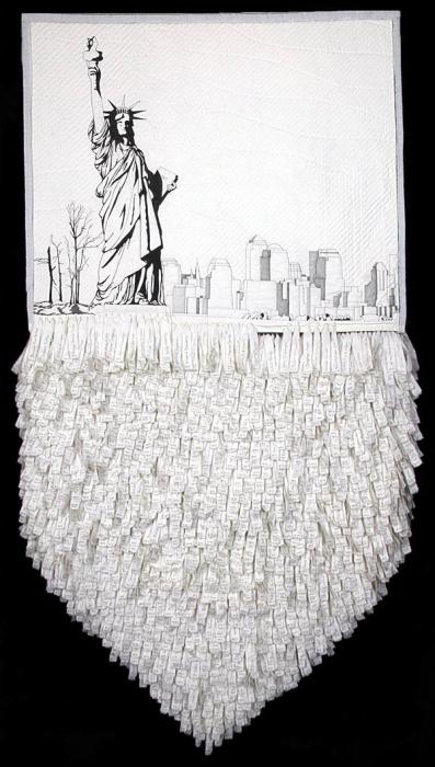 Memorial quilt of the Statue of Liberty and lower Manhattan skyline in black on white, with hundreds of hand-lettered fabric name strips hanging below.
