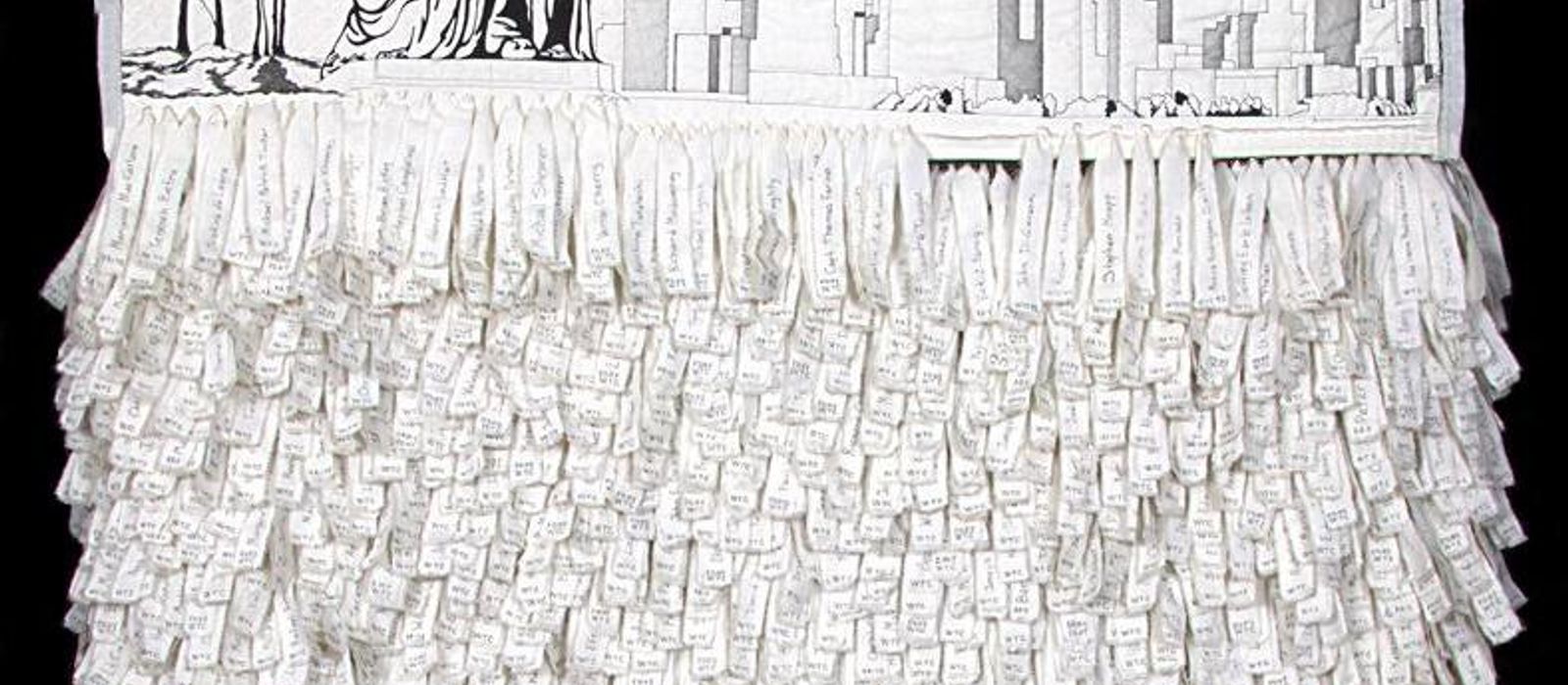Memorial quilt of the Statue of Liberty and lower Manhattan skyline in black on white, with hundreds of hand-lettered fabric name strips hanging below.