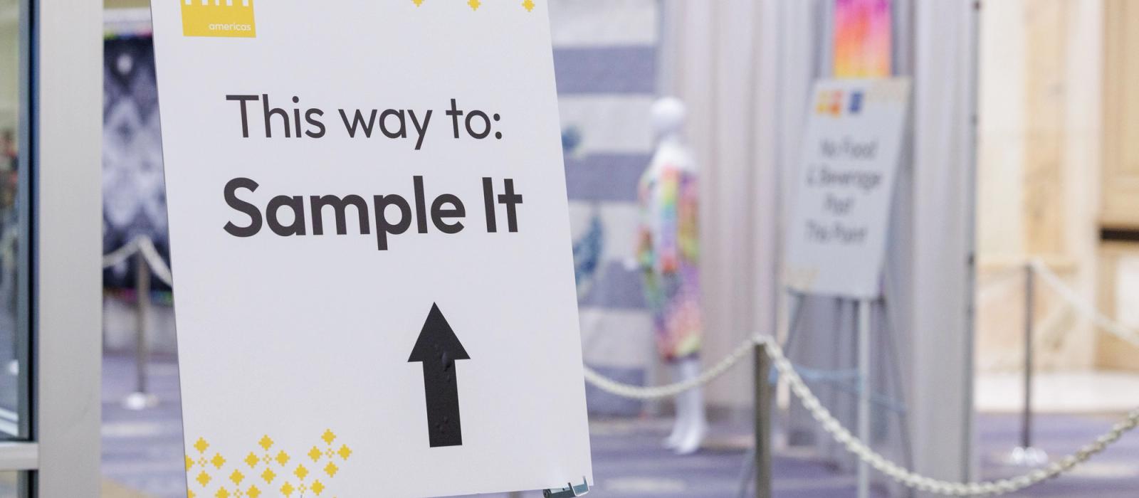 Display Poster with and arrow directing attendees and text "This Way to Sample It"